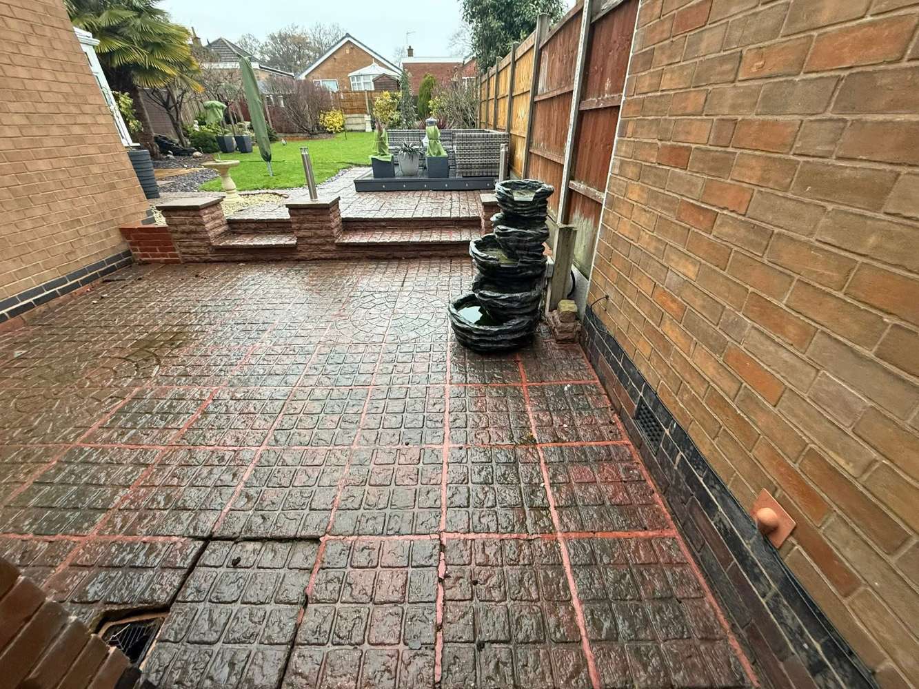 Uneven, tired patio, before